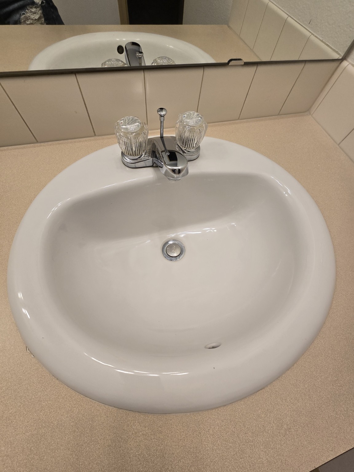 Clean white bathroom sink and polished faucet after cleaning