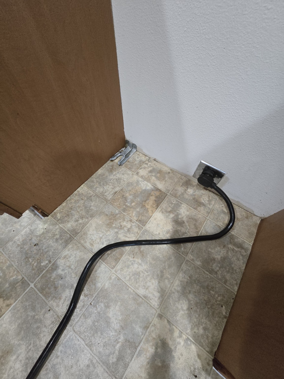 Floor behind the stove after dirt and debris were removed